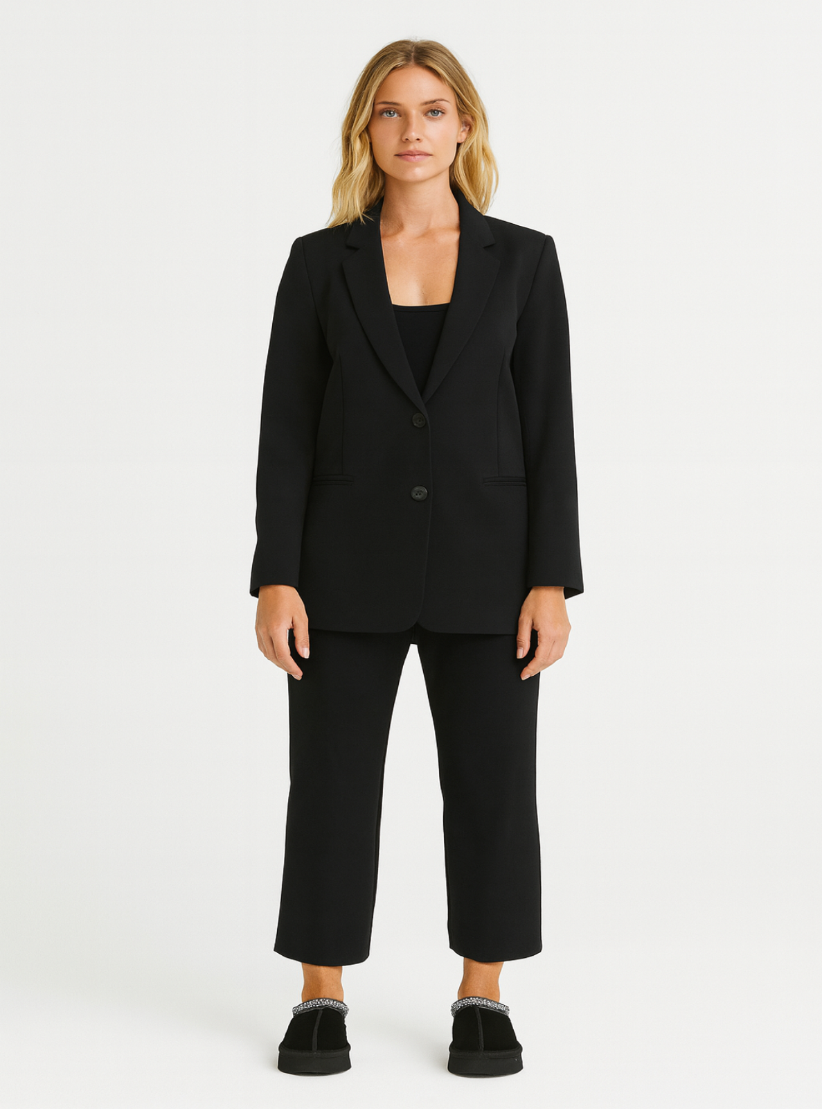Woman wearing a black suit on a white background