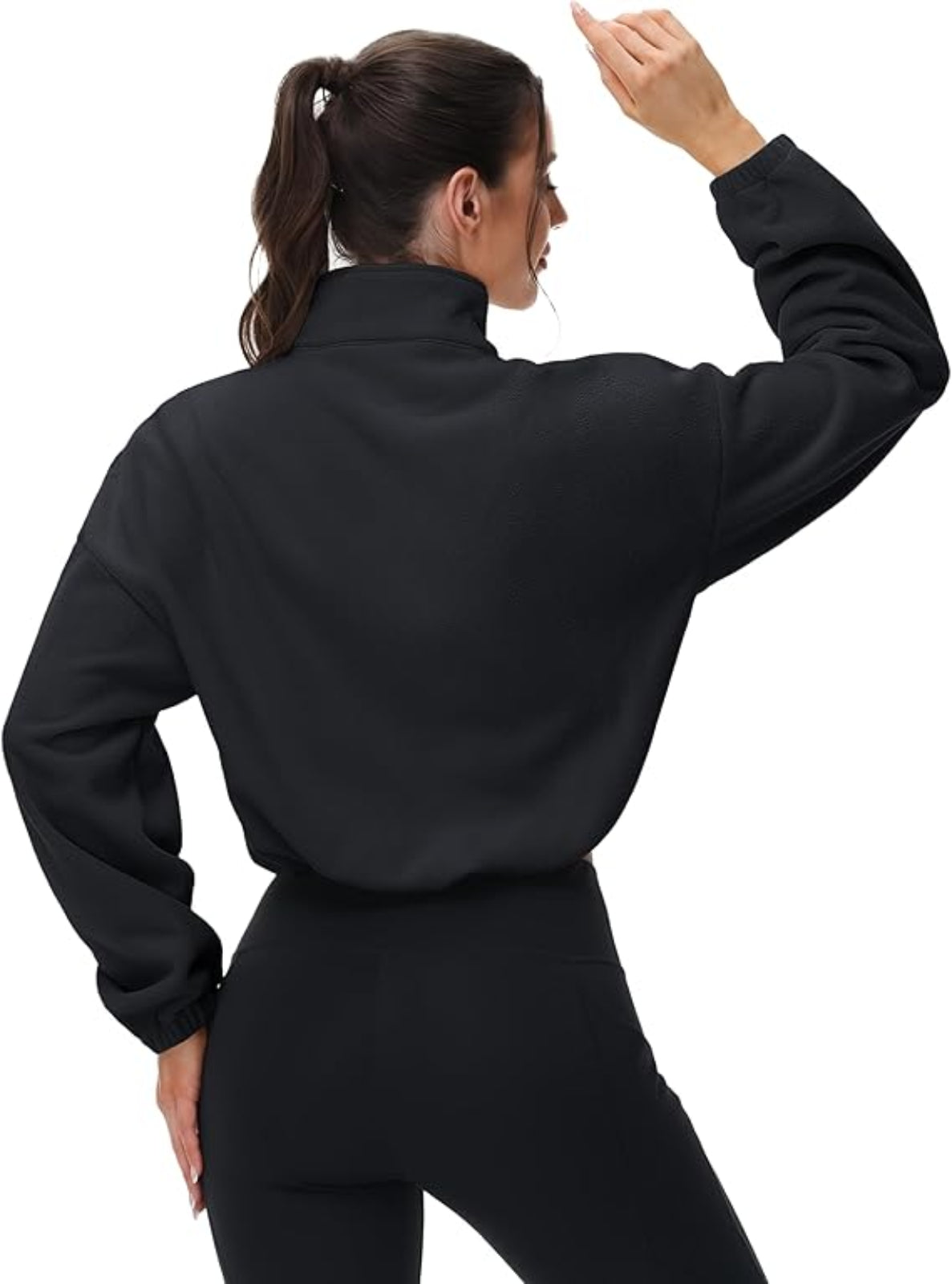 Person wearing a black jacket and pants on a white background