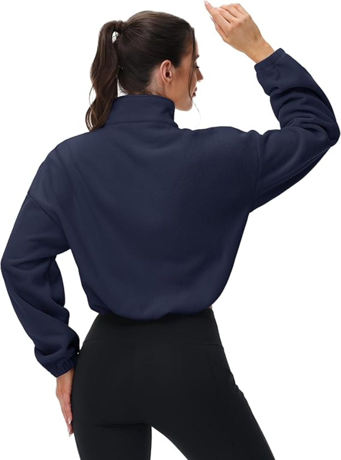 Person wearing a navy blue long-sleeve top on a white background