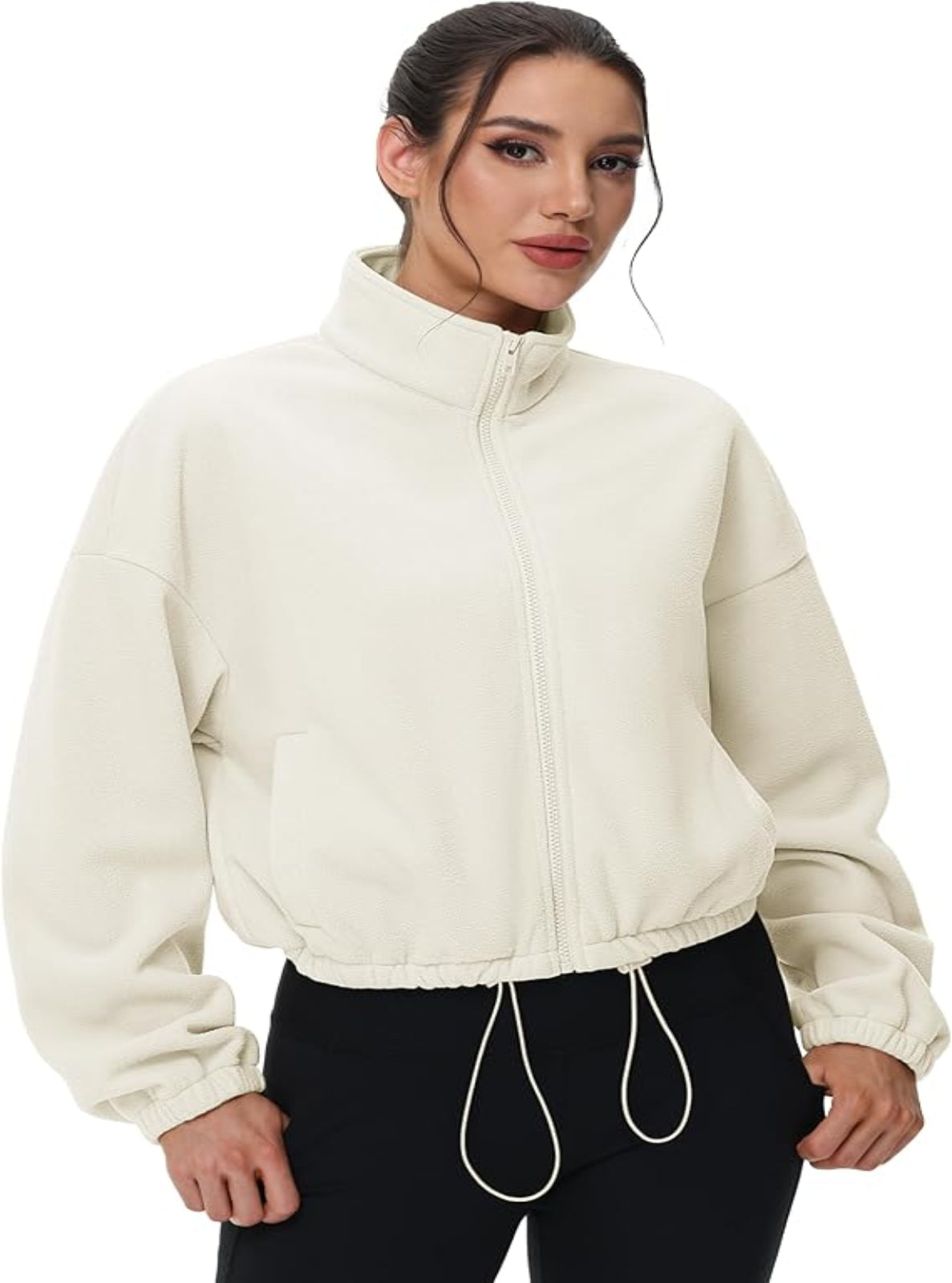 Woman wearing a cream-colored fleece jacket on a white background