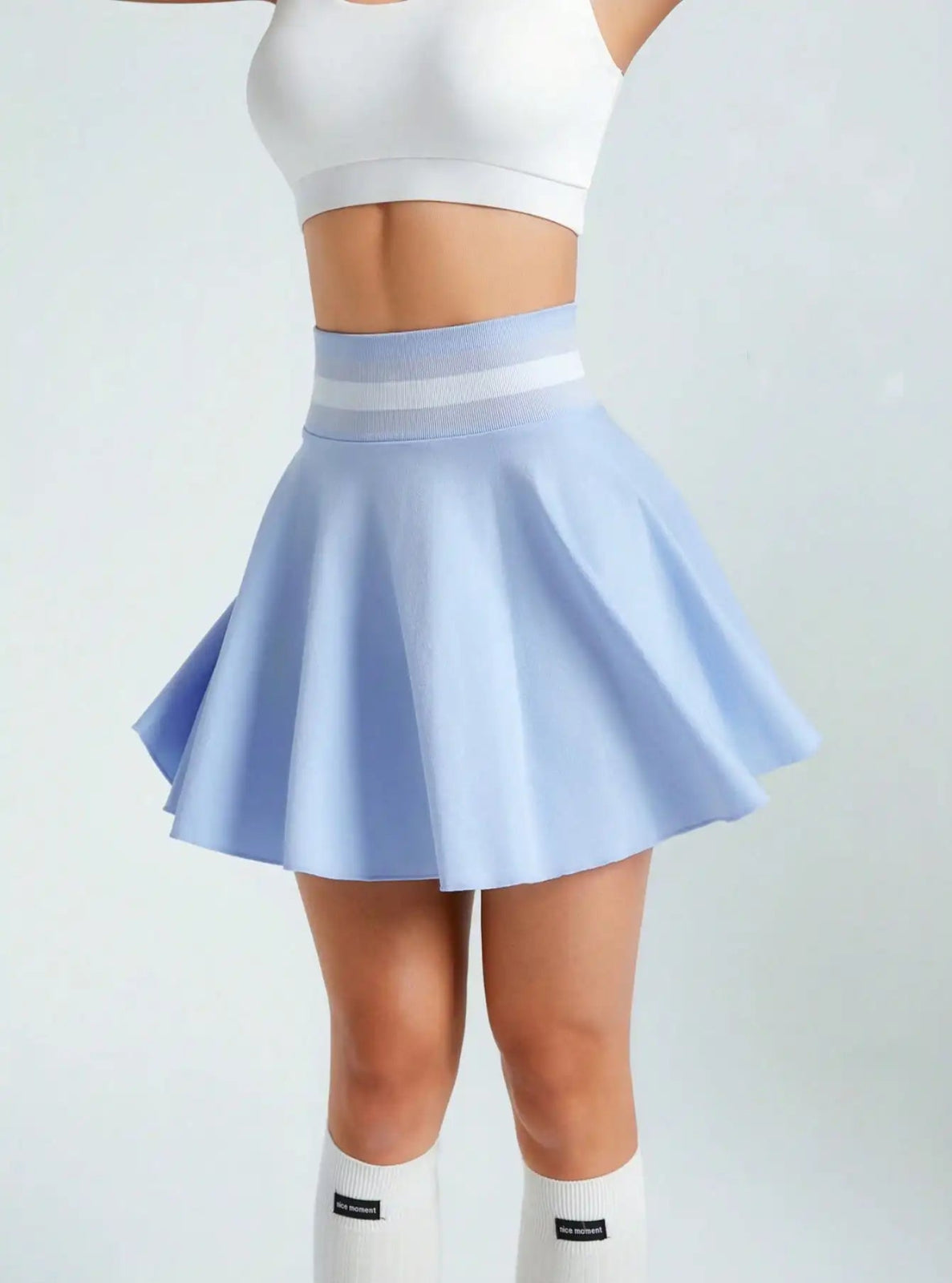 Light blue skirt worn by a person on a light gray background