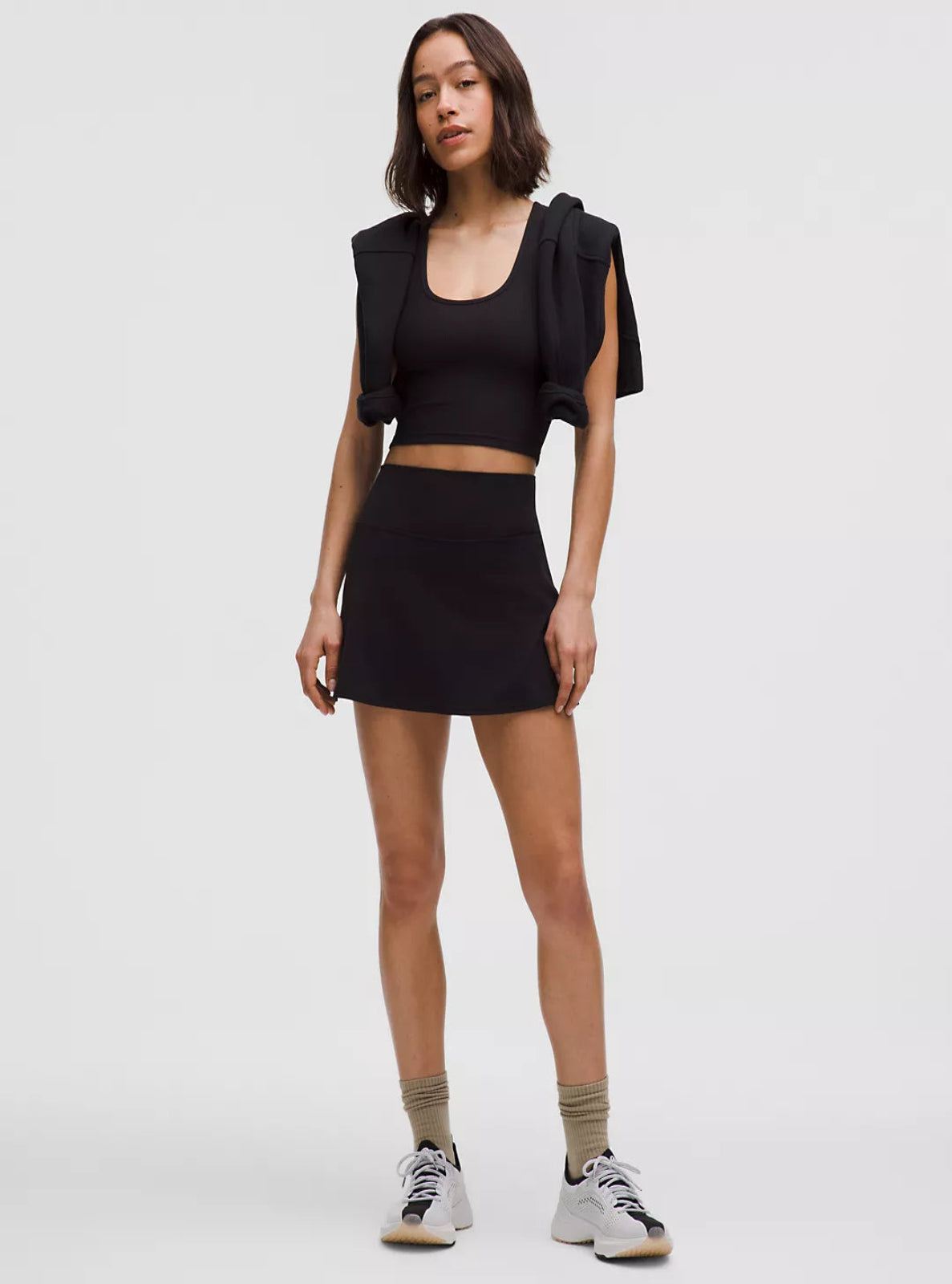 Woman wearing a black outfit with a white background