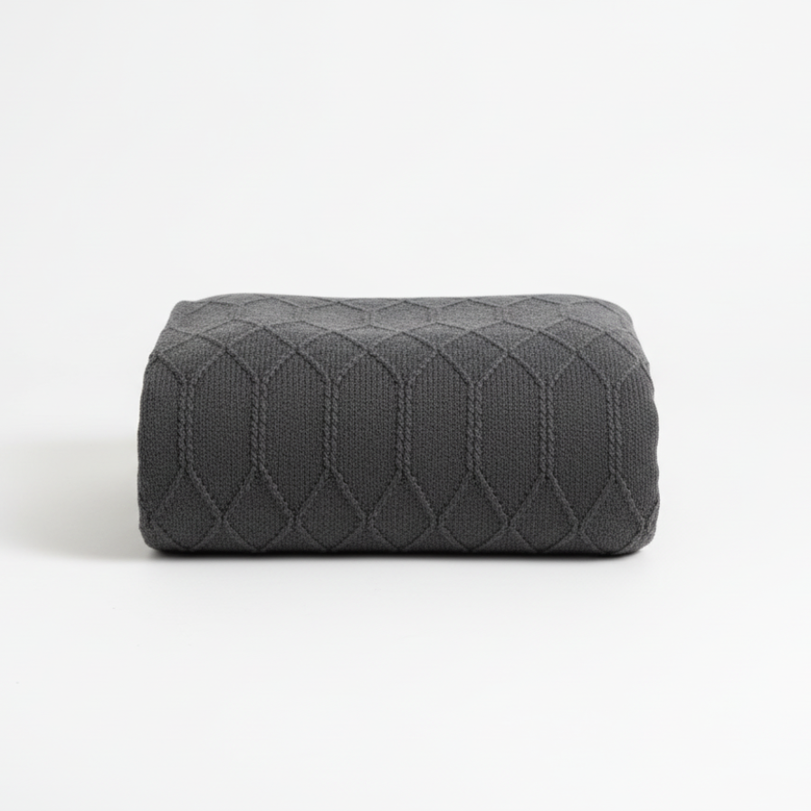 Gray quilted square pillow on a white background