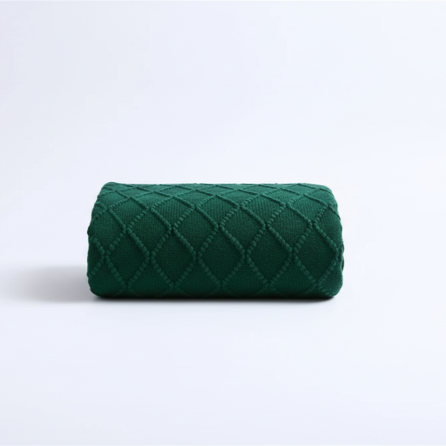 Green quilted fabric roll on a white background