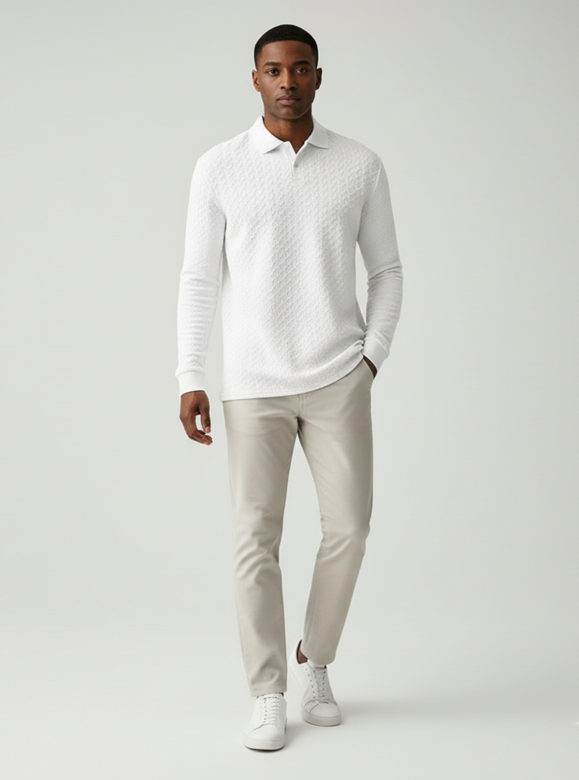 Man wearing a light gray sweater and pants on a white background