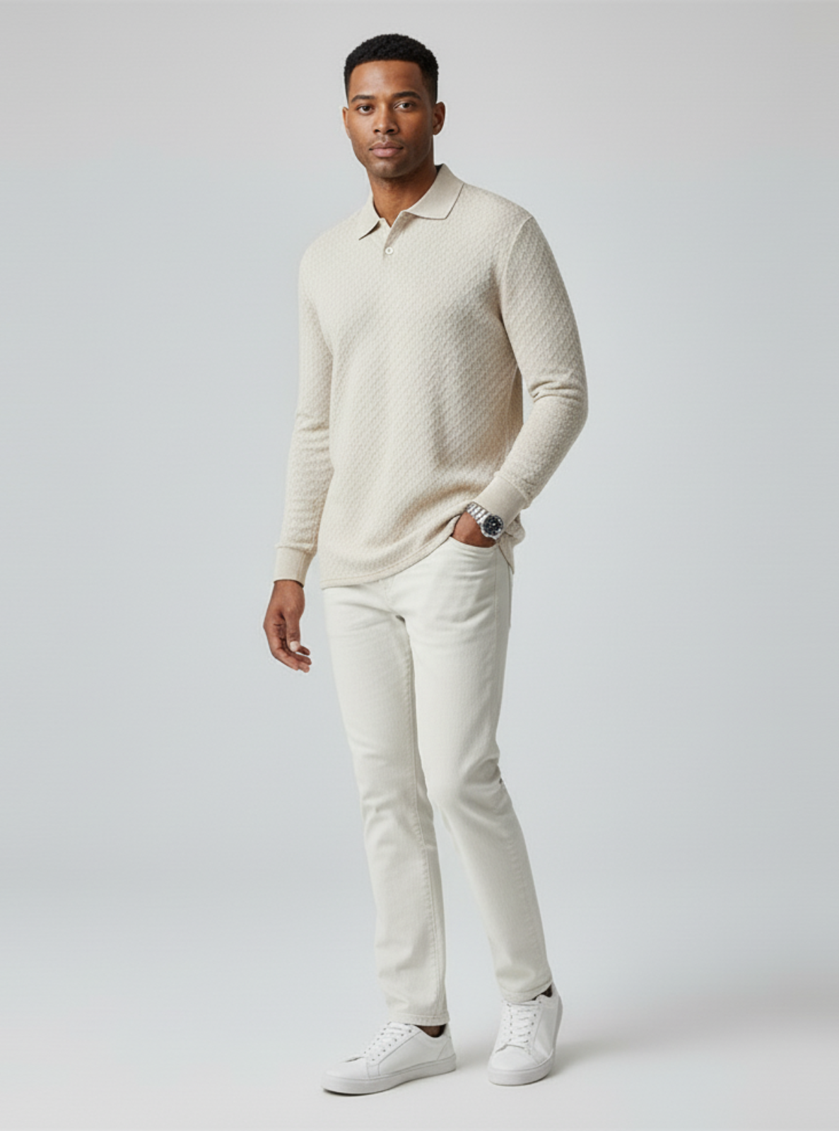 Man wearing a beige sweater and pants on a white background