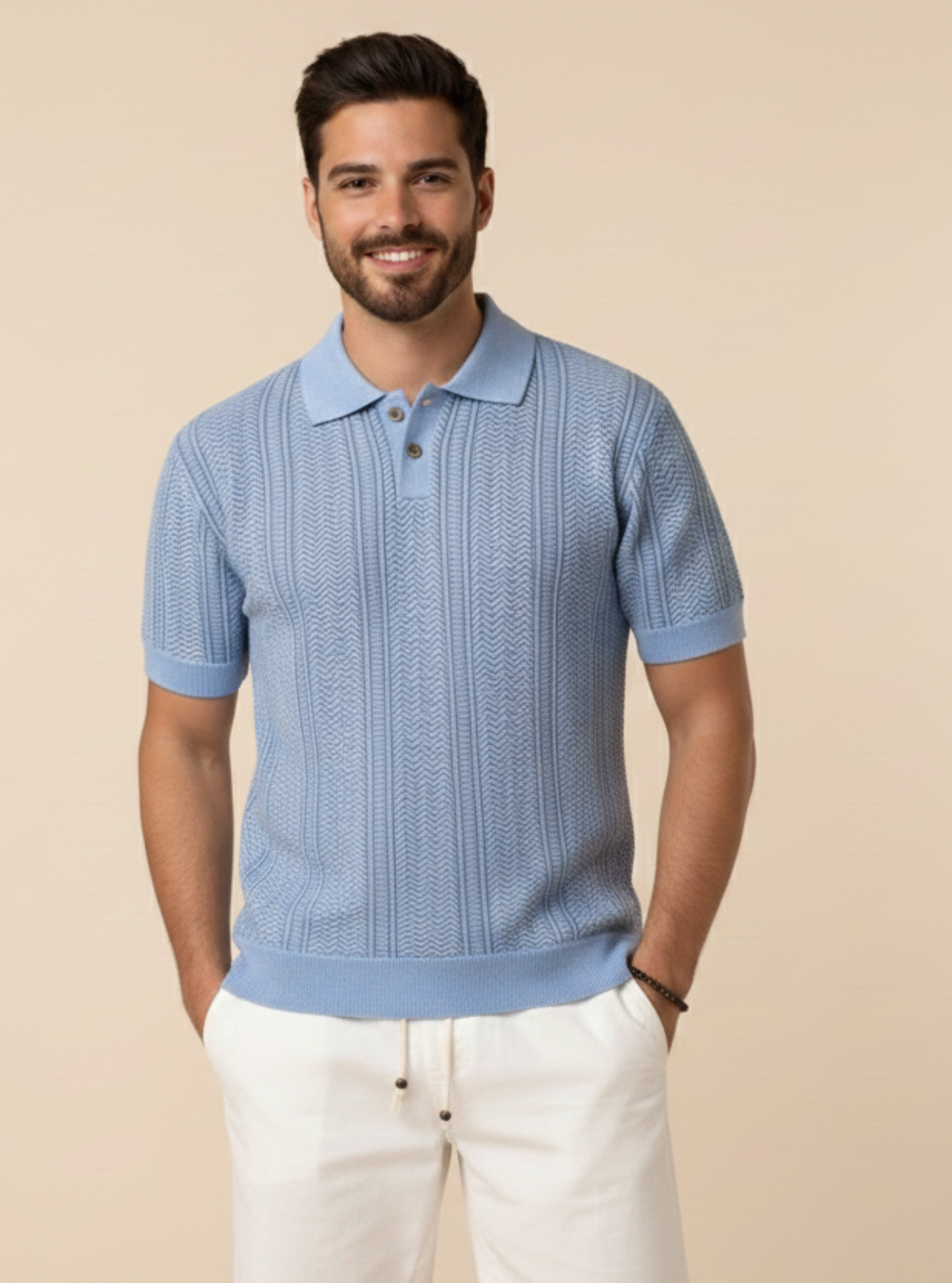 Man wearing a blue textured polo shirt and white pants against a beige background