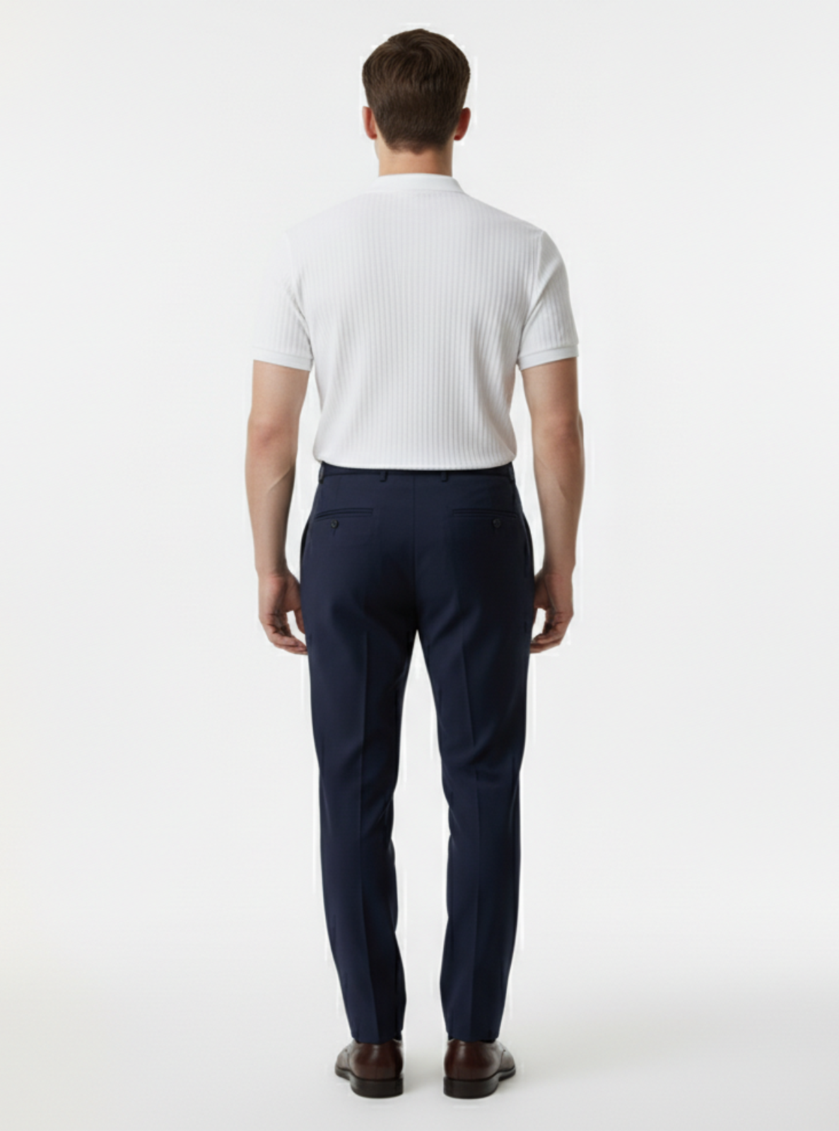 Man wearing a white shirt and navy pants on a white background