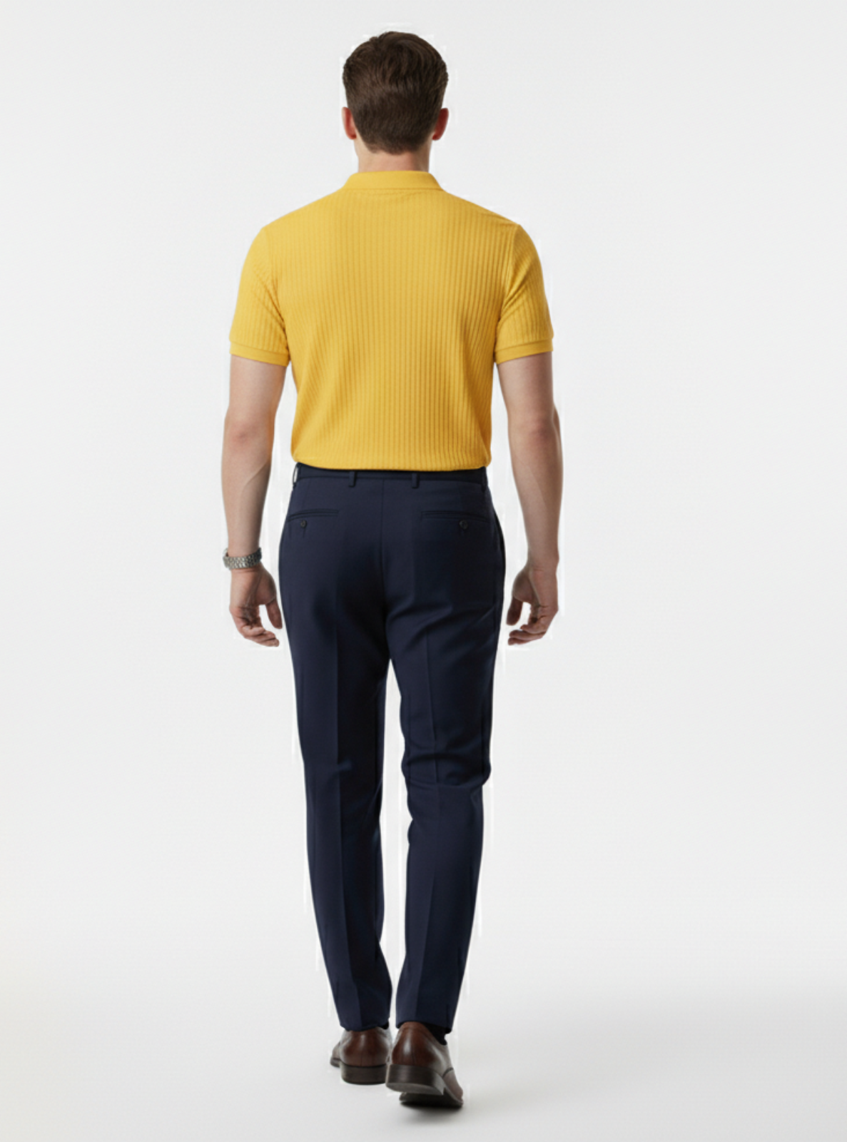 Man wearing a yellow polo shirt and navy pants on a white background