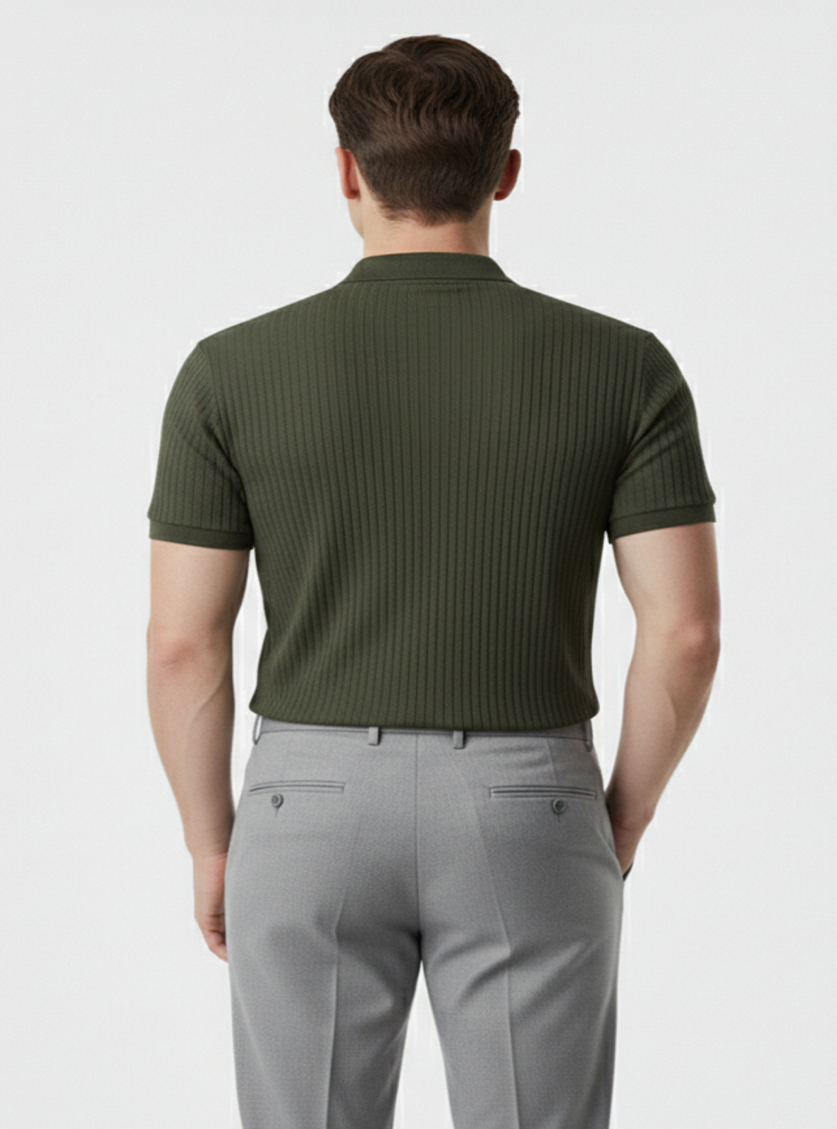 Man wearing a green polo shirt and gray pants on a white background