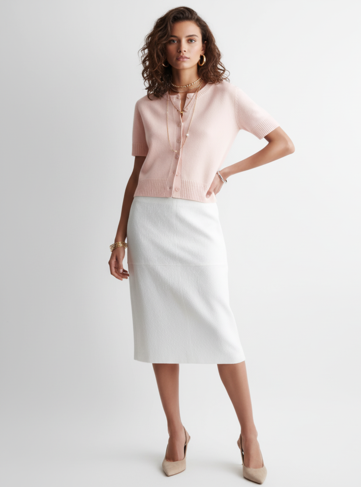 Woman wearing a pink blouse and white skirt on a light gray background