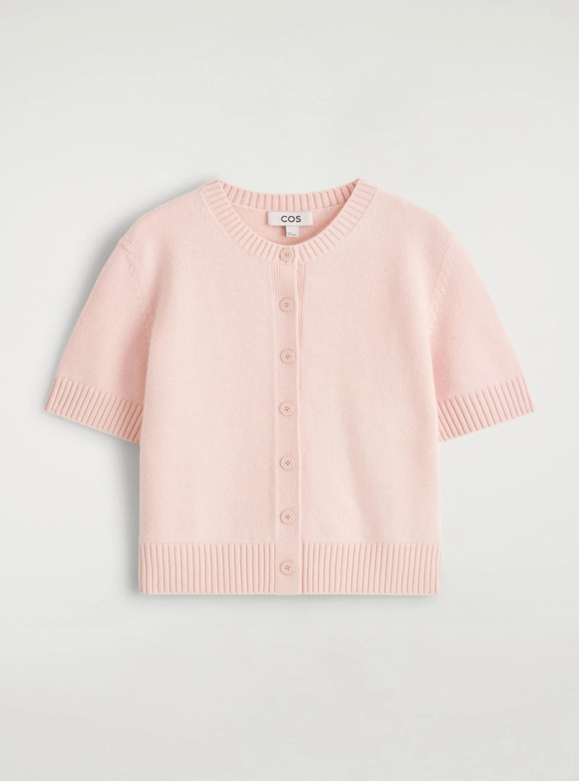 Pink cardigan on a light gray background