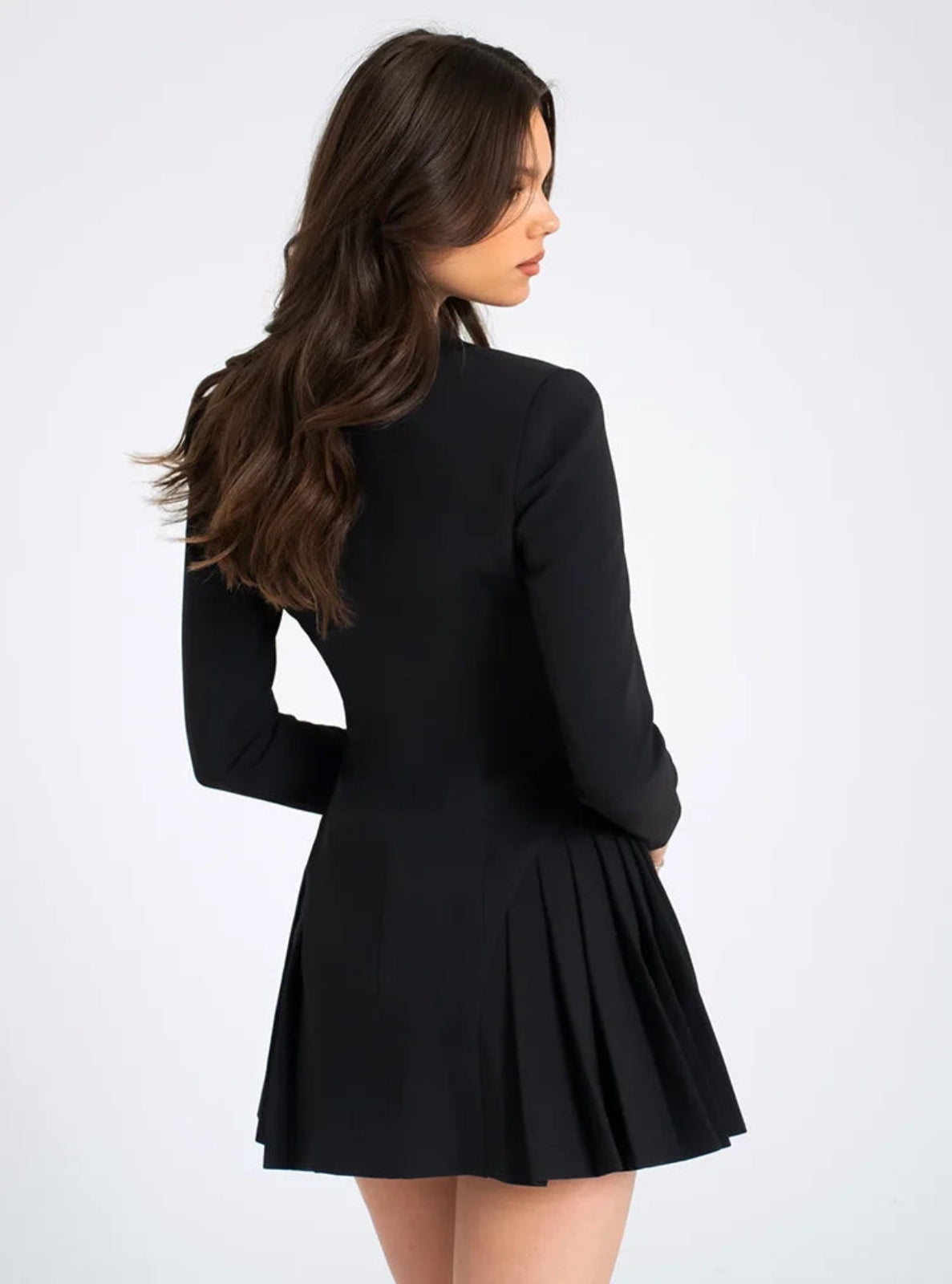 Woman wearing a black dress with a plain white background