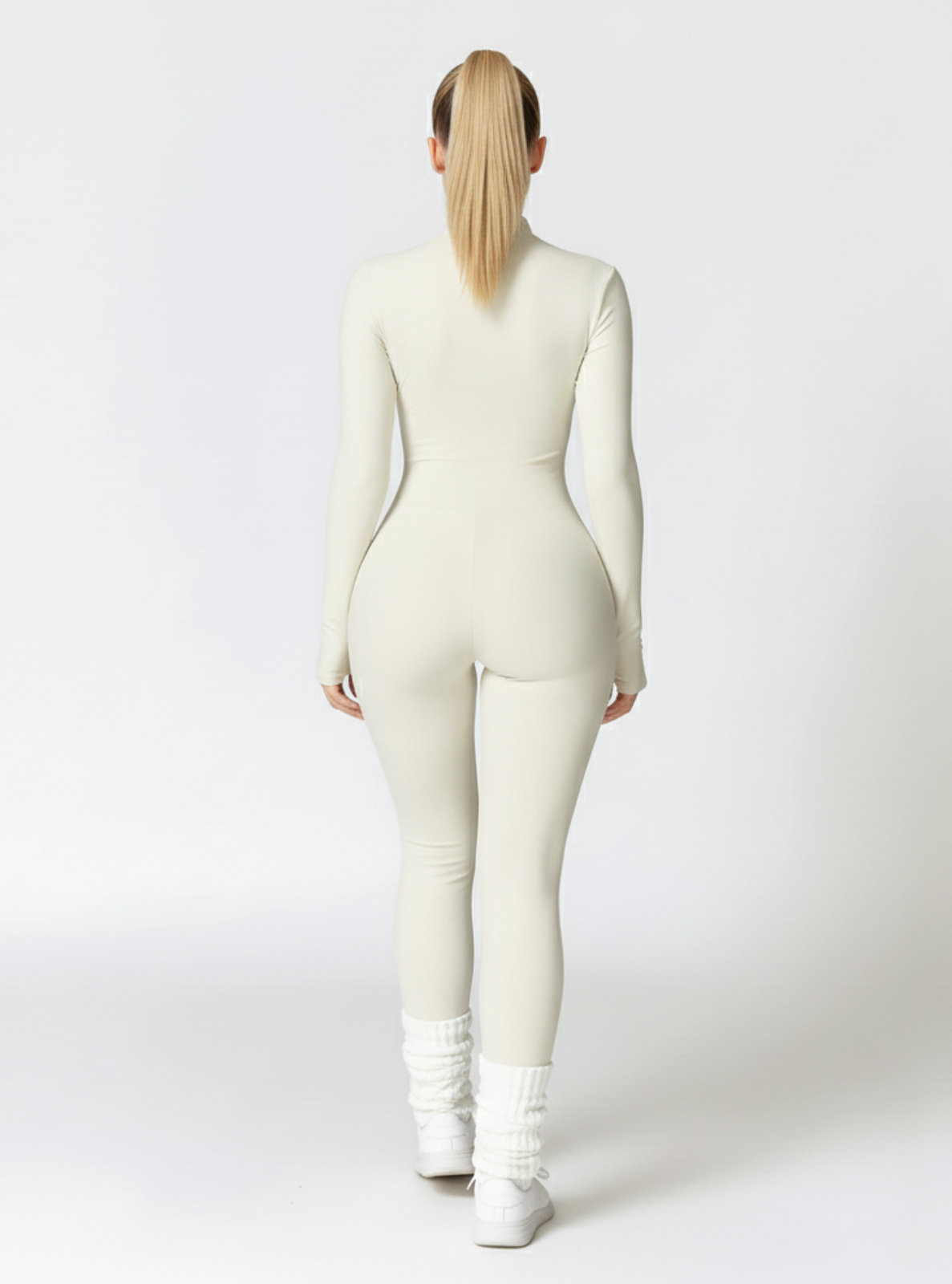 Person wearing a white bodysuit on a white background