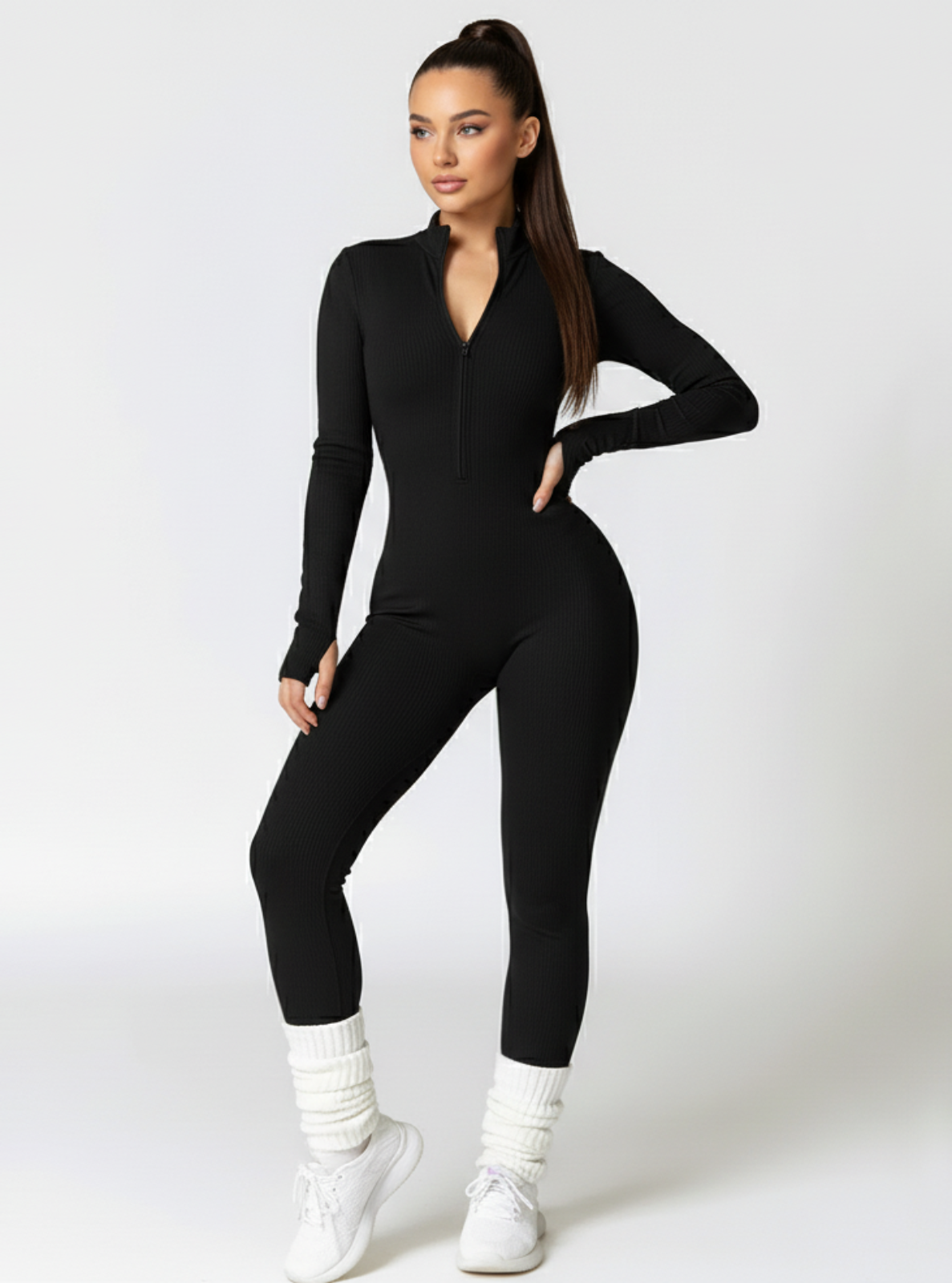 Woman wearing a black jumpsuit on a white background