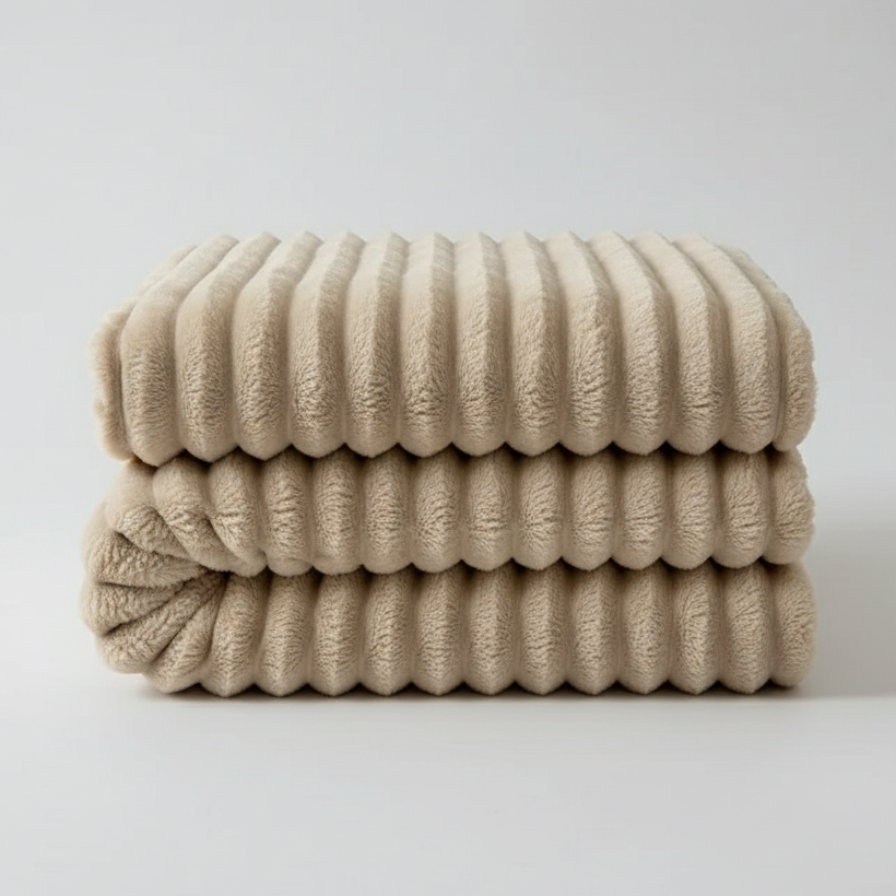 Stack of beige textured towels on a light gray background