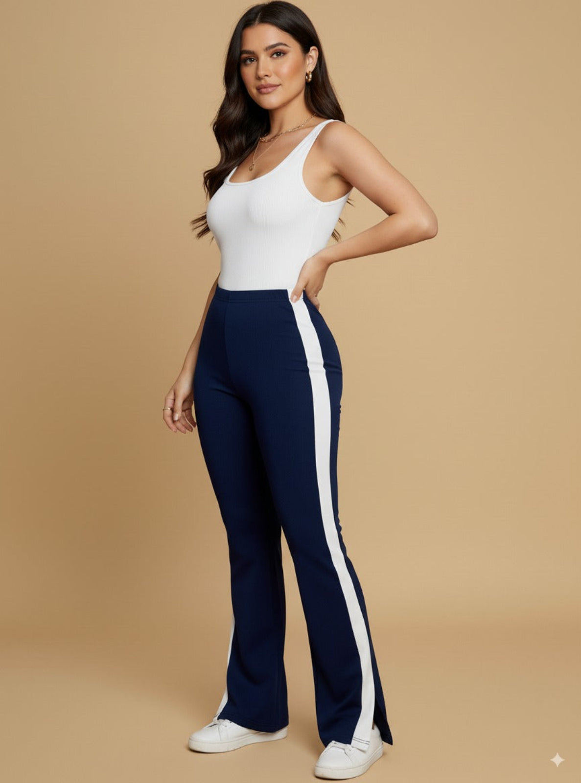 Woman wearing a white top and navy pants with a white stripe on a beige background