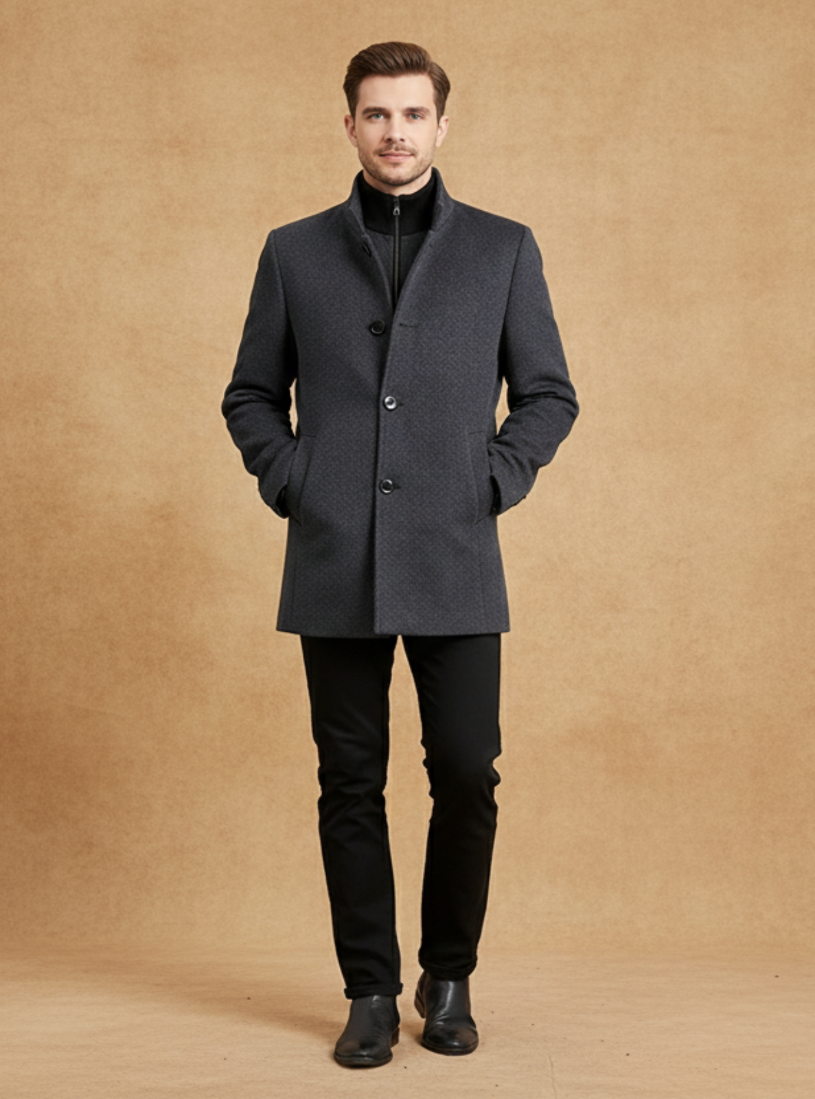 Man wearing a gray coat and black pants against a brown background