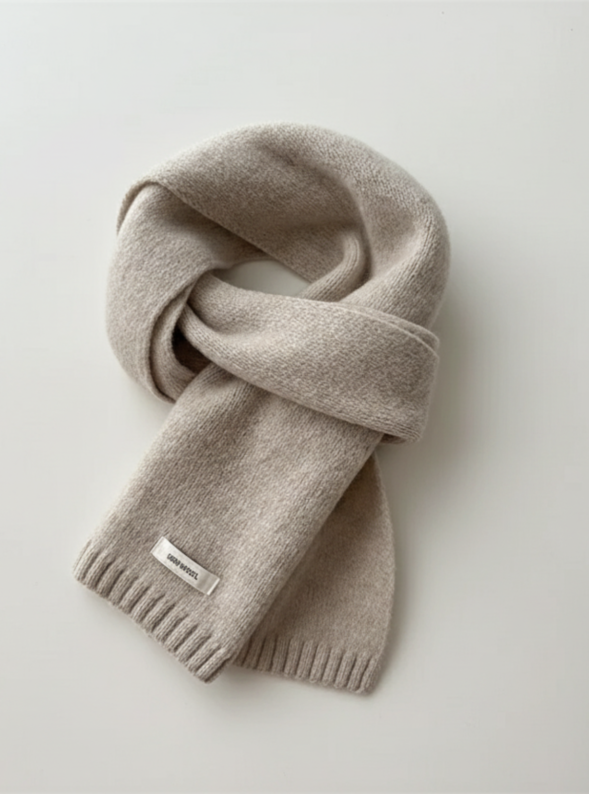 Gray scarf with a brand logo on a light gray background