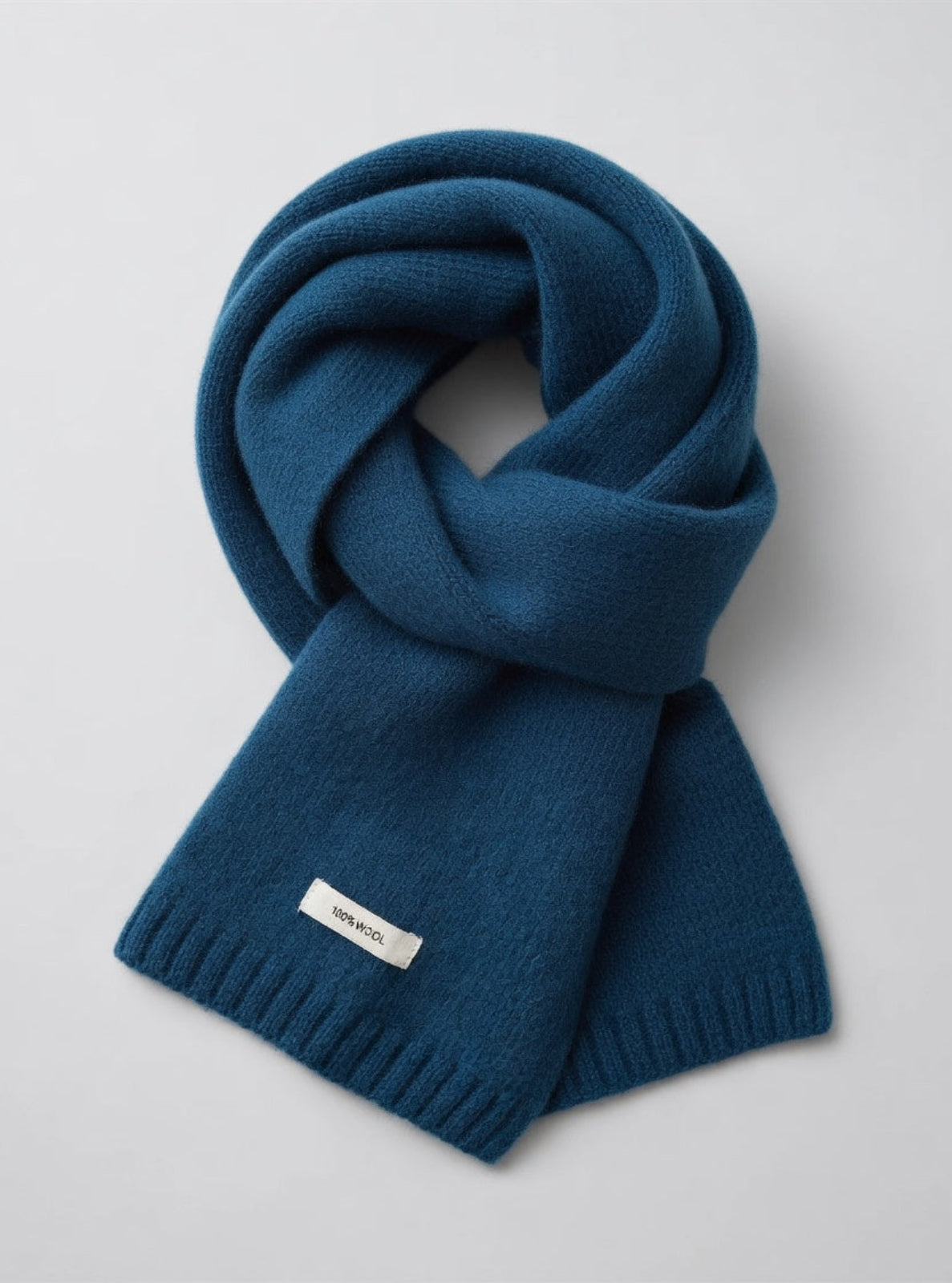 Blue scarf with a brand label on a light gray background