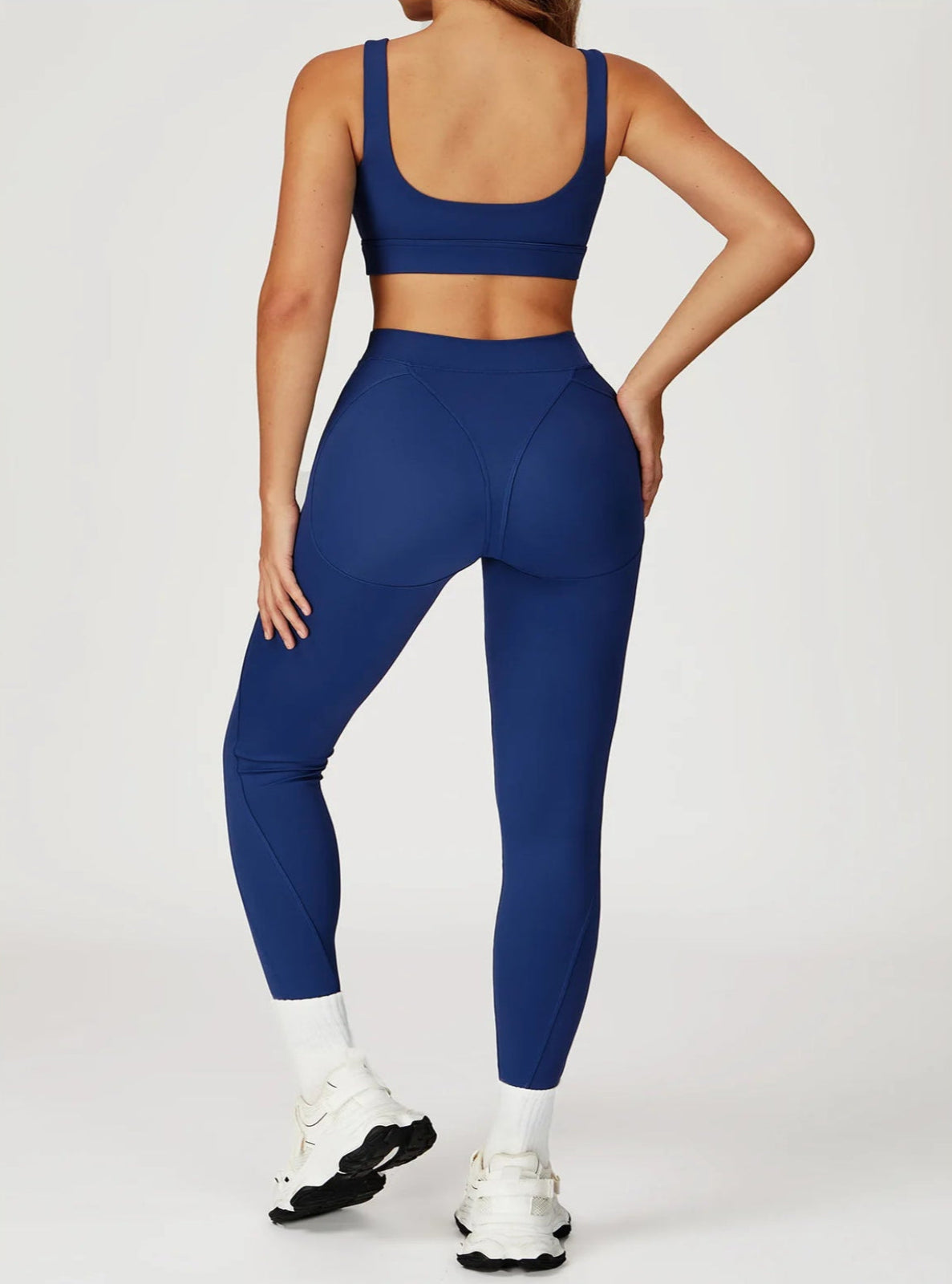 Person wearing a blue athletic outfit on a white background