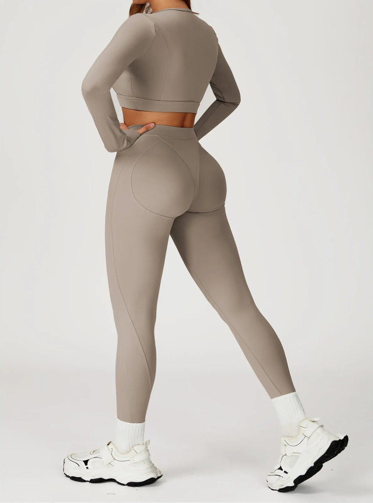 Person wearing a beige athletic outfit on a white background