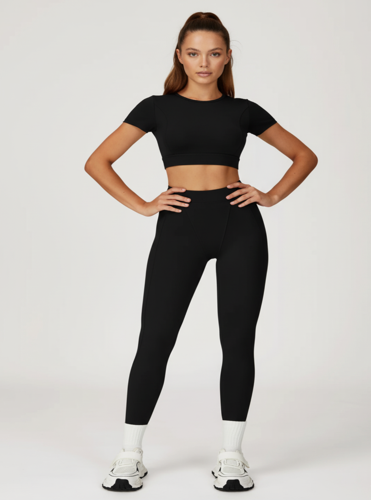 Person wearing a black athletic outfit on a white background