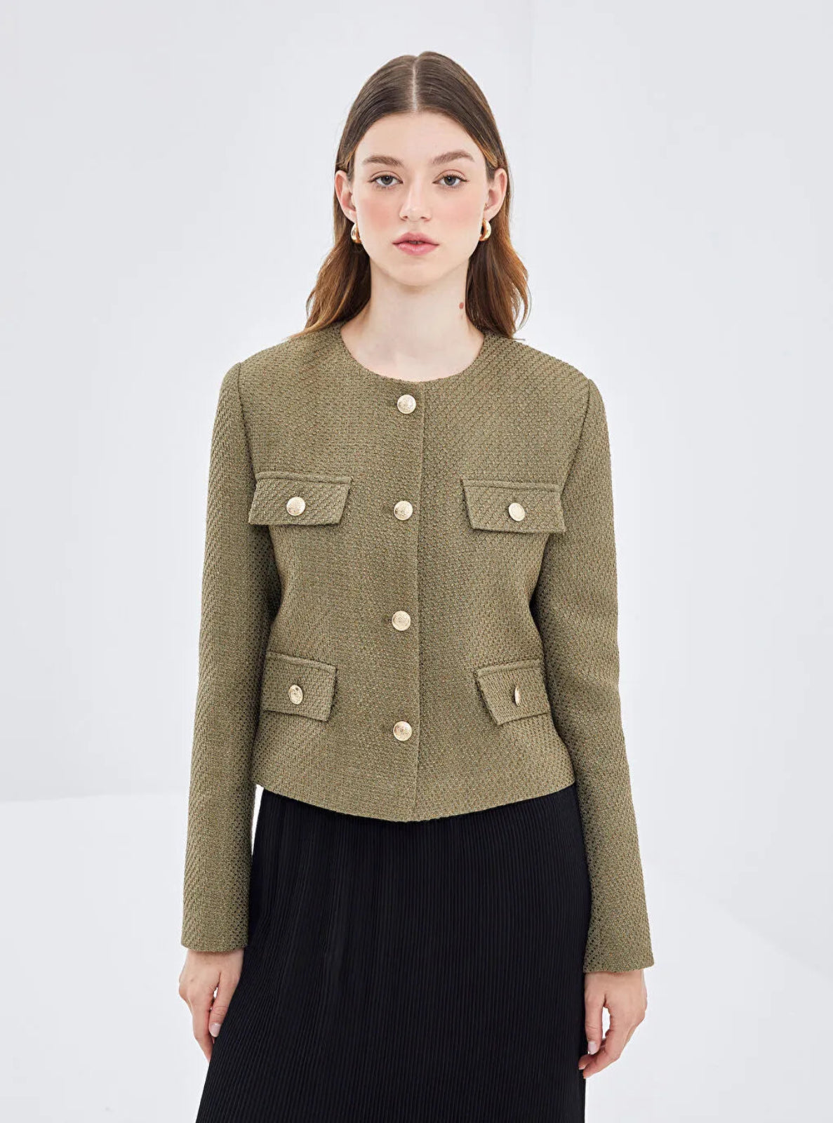 Model wearing a khaki textured Jacket in front of  a white background