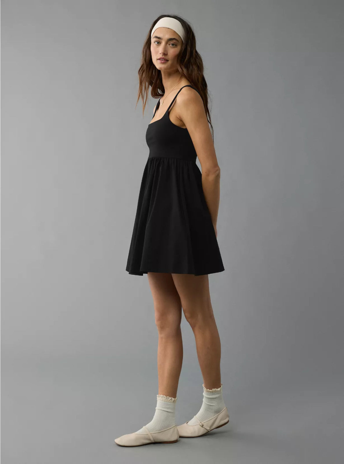 Woman wearing a black dress and white headband