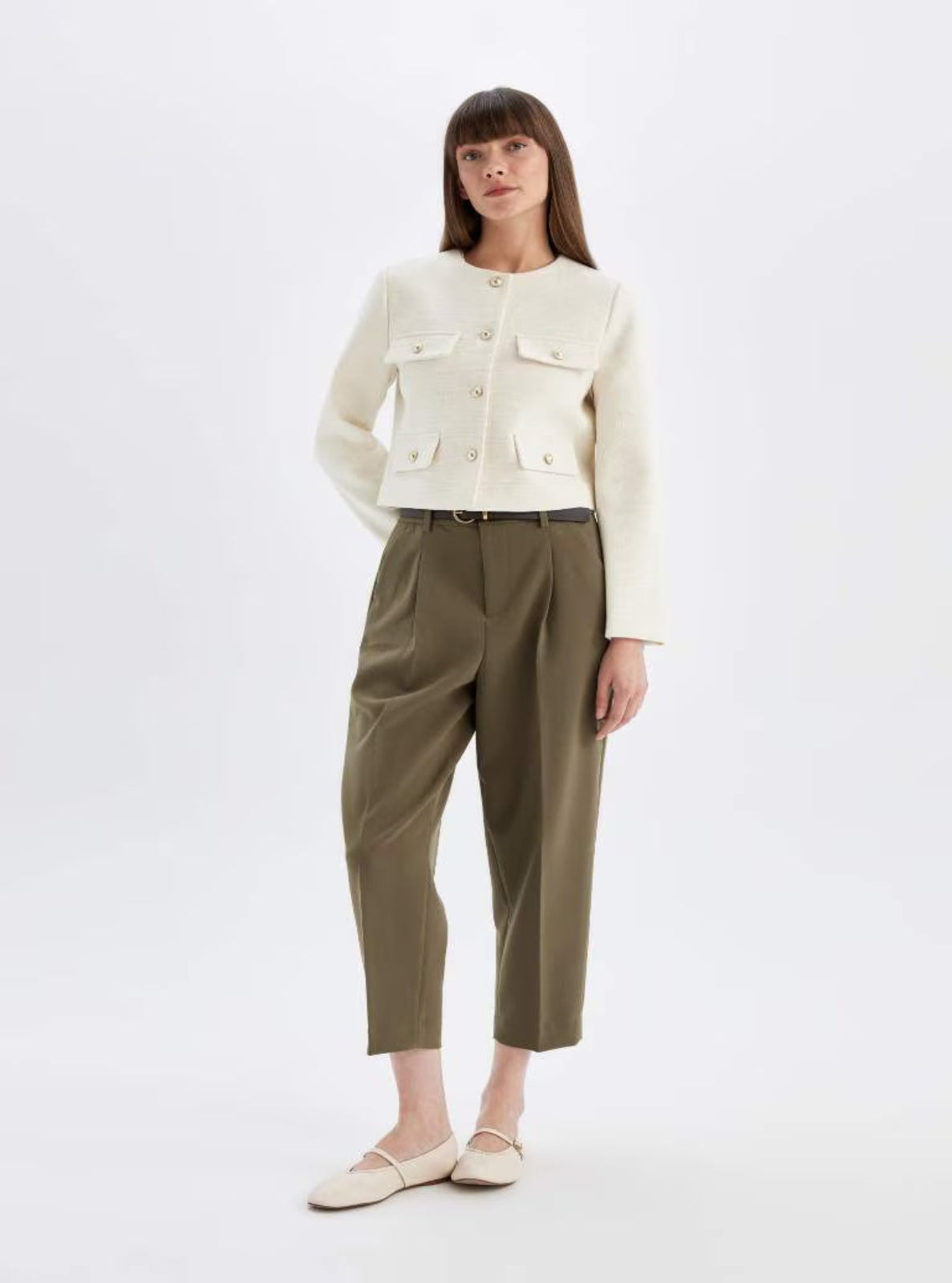 Model wearing a white textured Jacket with khaki pants and ballet flats 
